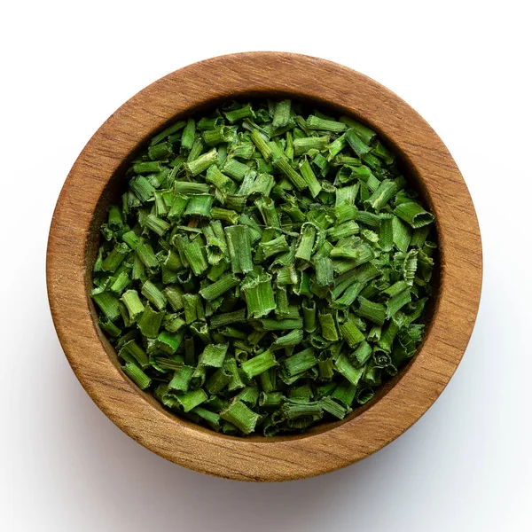 Dried chopped chives in a dark wood bowl isolated on white from — Stock Photo, Image