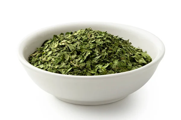 Dried chopped coriander leaves in white ceramic bowl isolated on — Stock Photo, Image