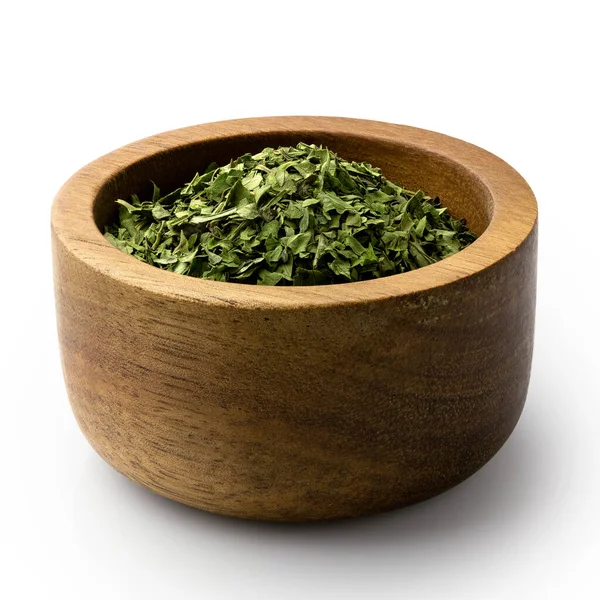 Dried chopped coriander leaves in a dark wood bowl isolated on w — Stock Photo, Image
