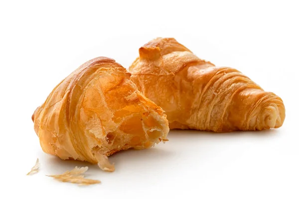 One and half baked plain croissants isolated on white. — Stock Photo, Image