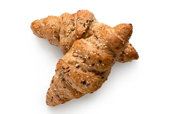 Two whole wheat croissants with linseeds and sesame seeds isolat — Stock Photo, Image