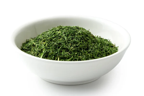 Dried chopped dill in white ceramic bowl isolated on white. — Stock Photo, Image