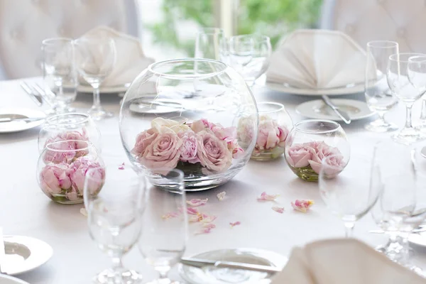 Detail der weißen Hochzeitstisch-Einrichtung mit frischen rosa Rosen in gl — Stockfoto