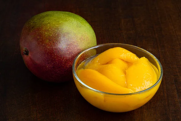 Konserverade Mangoskivor Sirap Glasskål Bredvid Hel Färsk Mango Isolerad Vitt — Stockfoto