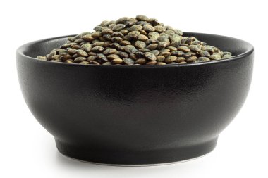 Dry french green puy lentils in black ceramic bowl isolated on white. Low angle. clipart