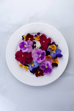 Edible flowers on a plate clipart