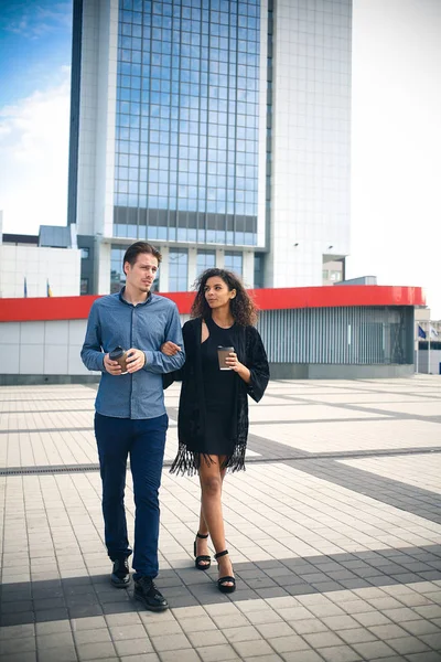 Modern business man and woman wearing smart casual clothes in the city. Urban lifestyle.