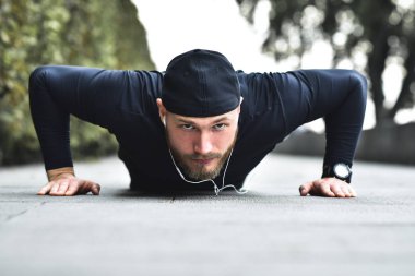 Genç sporcunun yapar egzersiz bir park, push up açık bir dizi yapıyor sakallı.