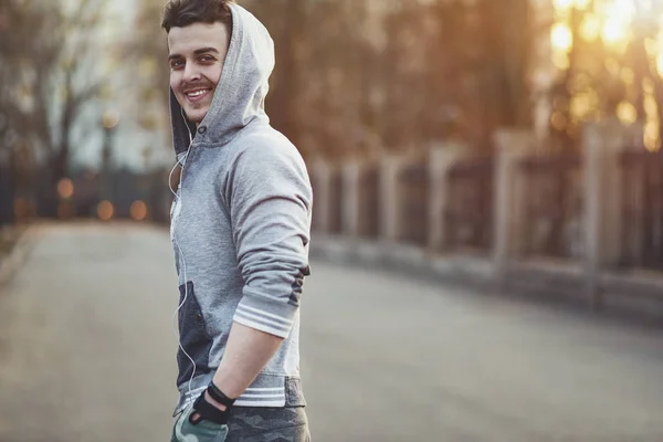 Jovem desportista sorridente, passeio matinal na rua . — Fotografia de Stock