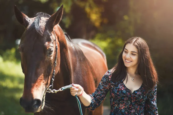 Beautiful Latin woman in dress and her lovely horse walk in the forest. love animals concept. love horses — Stock Photo, Image