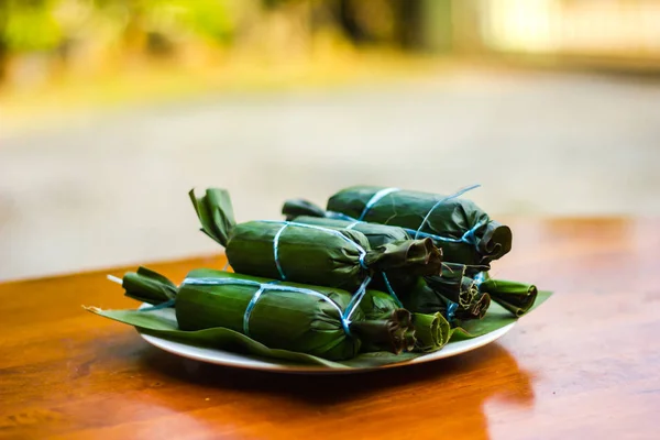 Ketupat Daun Pisang closeup çekim ahşap Tablo arka plan bulanıklık. Malezya mutfağı 