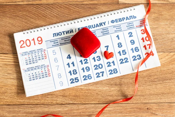 Calendar with red heart and ribbon. February 14