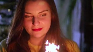 White butterfly sits on a yellow dandelion in the garden