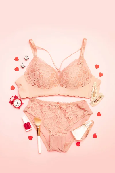 Flache Lagekomposition aus pinkfarbener sexy Damenunterwäsche mit Parfümkapazität auf rosa Hintergrund — Stockfoto