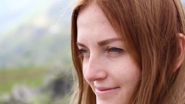 Closeup portrait of a young woman looking into the camera — Stock Video