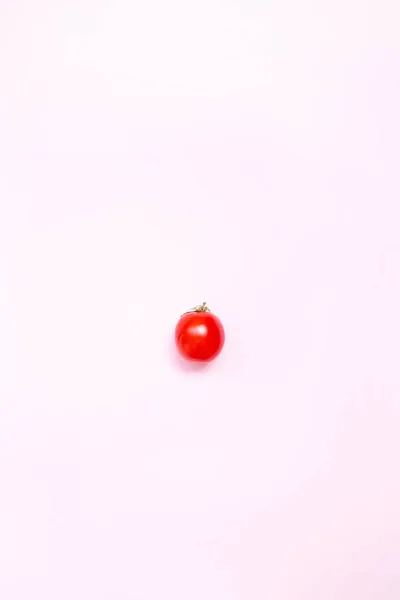 Flat lay. Food concept. Red ripe tomato on a pink background — Stock Photo, Image