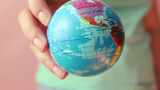 Female hand holds planet earth ball. Save the planet concept. Global warming and plastic emissions. — Stock Video