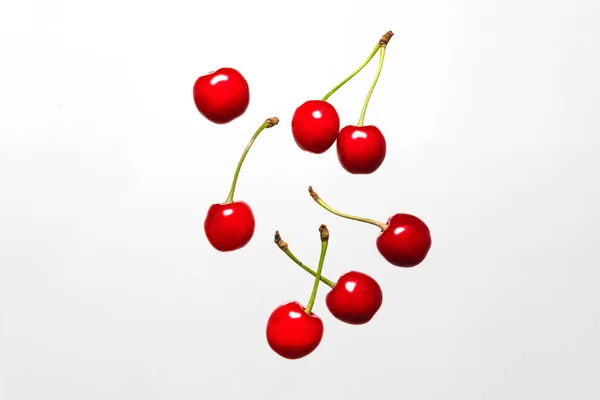 Ripe cherry berry levitating on a grey background. Cherry pattern. Berry summer background. Flat lay, top view, copy space — Stock Photo, Image