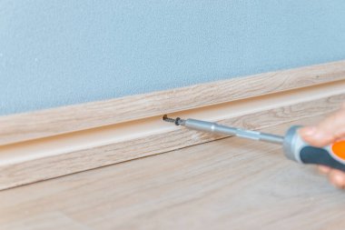 Duvara bir etek tahtası dayayarak. Plastik pedin kurulumu