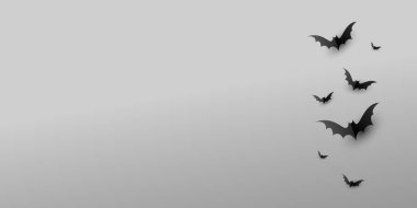 Gri arkaplanlı ve fotokopi alanı olan kağıt korkutucu siyah yarasalar. Cadılar Bayramı ve dekorasyon konsepti