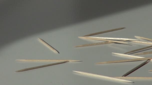 Mano de hombre quita palillos de dientes dispersos en la mesa — Vídeo de stock