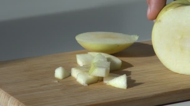 Trozos de manzana verde cortada sobre tabla de cortar de madera — Vídeos de Stock