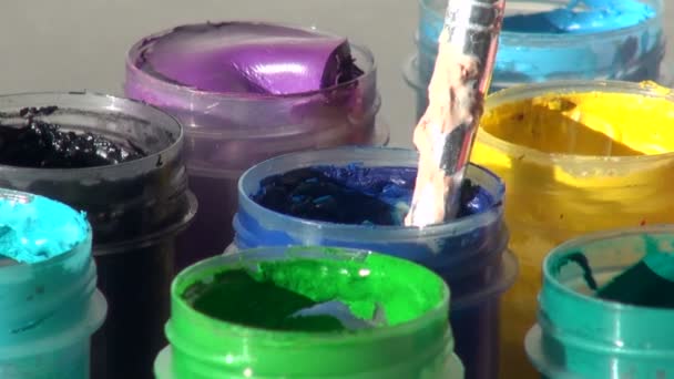 Brush immersed in a jar of blue Acrylic gouache paint. Homework, — Stock Video