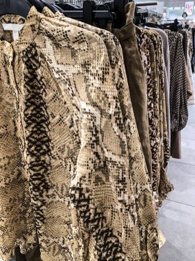 Mağazadaki askıda kadın kıyafetleri - paltolar, ceketler, bluzlar