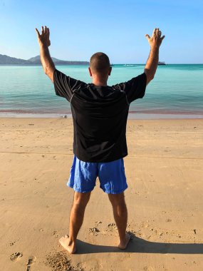 Egzersiz yapan, plajda spor yapan bir adam.