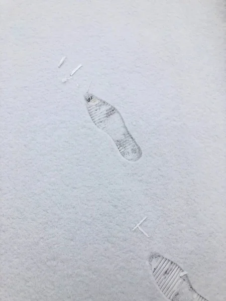 footprints in the snow, the first snow in the winter