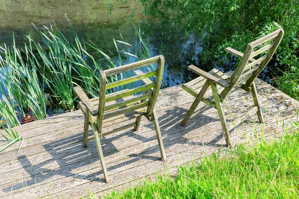 Picture Weathered Wooden Chairs Wooden Deck Pond — Stock Photo, Image