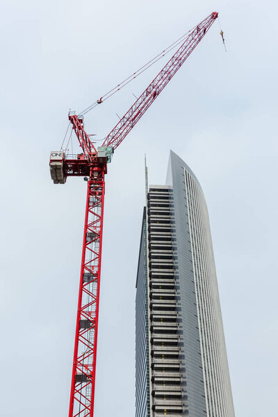 Frankfurt am Main, Germany - January 07, 2019: crane beside the Pollux Tower in Frankfurt. It is one of the twin towers Castor and Pollux, with a height of 130 metres and 33 storeys