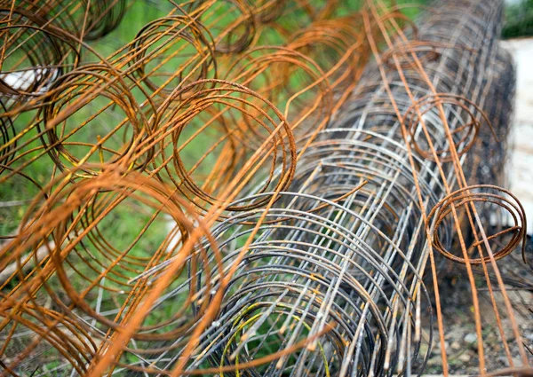 close up rusty iron net on green park