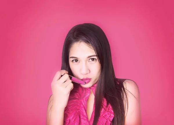 cute asian lady smile with pink lipstick on studio shot.