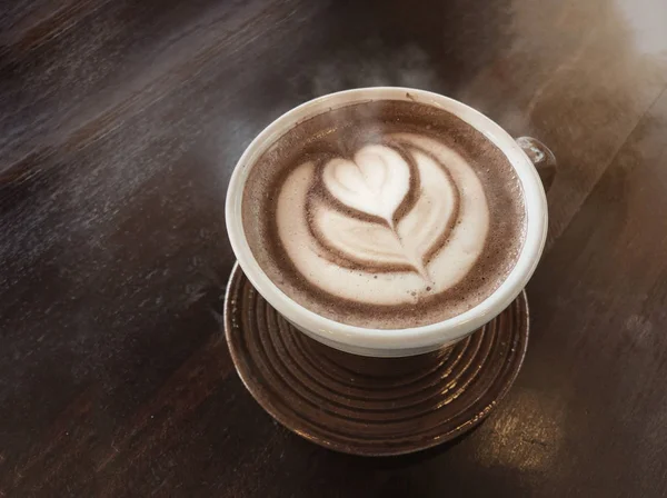 love hot coffee with smoke by latte art on a cup