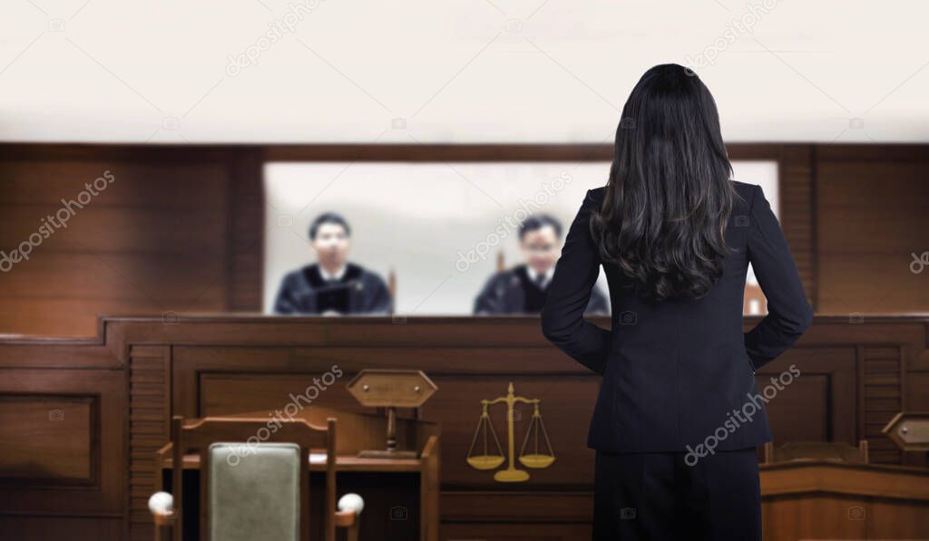 back of woman authorny on courtroom talking to magistrate in court. The law adjustment concept