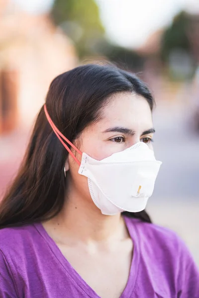 Virus mask young woman wearing face protection in prevention for coronavirus in Spain, Madrid in the street