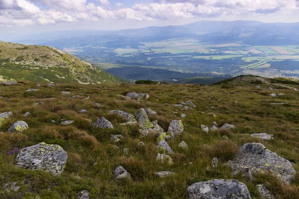 Mountain alpine landscape at summer. Alpine meadow, boulders, against the backdrop of mountain peaks. View from the mountain Krivan, High Tatras - national symbol of Slovakia . Concept of travel, hiking. Tourist destination