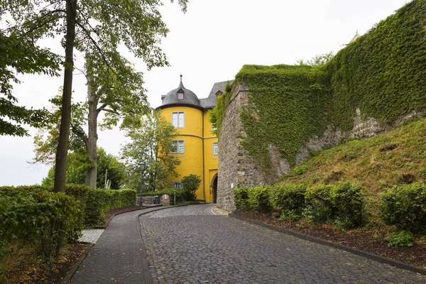 Ancient historical castle Montabaur. Cobblestone road leading to the castle, main entrance.  Rhineland-Palatinate, Germany.  National German cultural heritage. Tourist destination, tourist attraction