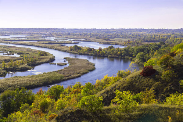 Panorama of Vorskla river delta at summer day. Nature reserve landscape of Ukraine. Beautiful view from above on a meandering flat river- flood plain. Aerial photography of flooded floodplai