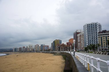 Birkaç bina ve güneş ışığı ile bir plaj fotoğrafı