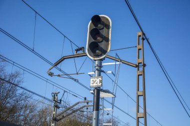 Photo of a traffic lights with blue sky and sunlight clipart