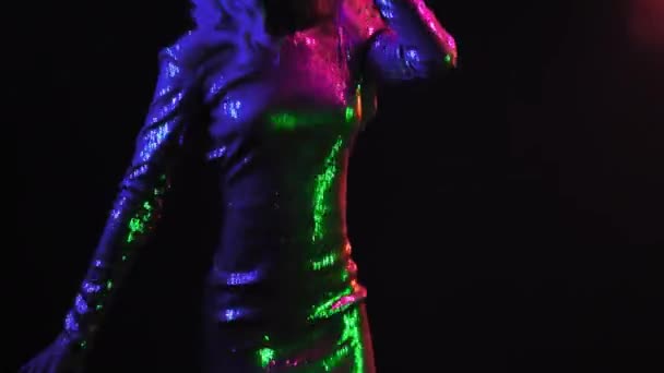 Afro-Amerikaanse blonde model dansen in neon lichten geïsoleerd op zwarte achtergrond. Mooi meisje dansend in de studio in een zilveren glanzende jurk. Neon concept. Prores 422 — Stockvideo