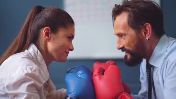 Woman struggling with man in business clothes trying hard to stand stronger and to resist. Business people vie boxing on gloves. Gender Conflict Concept. Prores 422