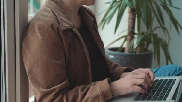 Piękna dojrzała bizneswoman z laptopem siedząca w przytulnej kawiarni opartej na oknie. atrakcyjna kobieta pracująca na stanowisku pracy. Dojrzała kobieta w kawiarni. Prores 422 — Wideo stockowe
