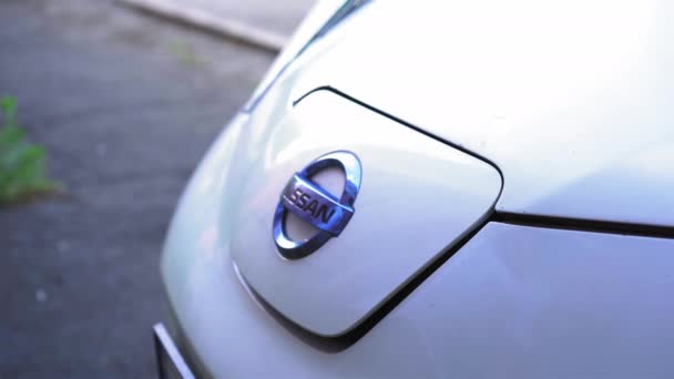 O homem põe o veículo eléctrico a carregar. Tampa no carro elétrico abre, o homem levanta e insere um plugue para carregar. Imagens 4k de alta qualidade. 30 de junho de 2020. Kiev, Ucrânia — Vídeo de Stock