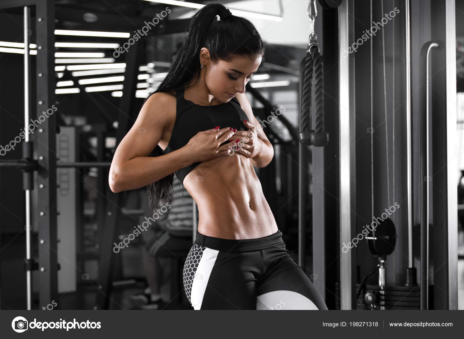 Beautiful athletic woman with long hair posing. Fitness girl