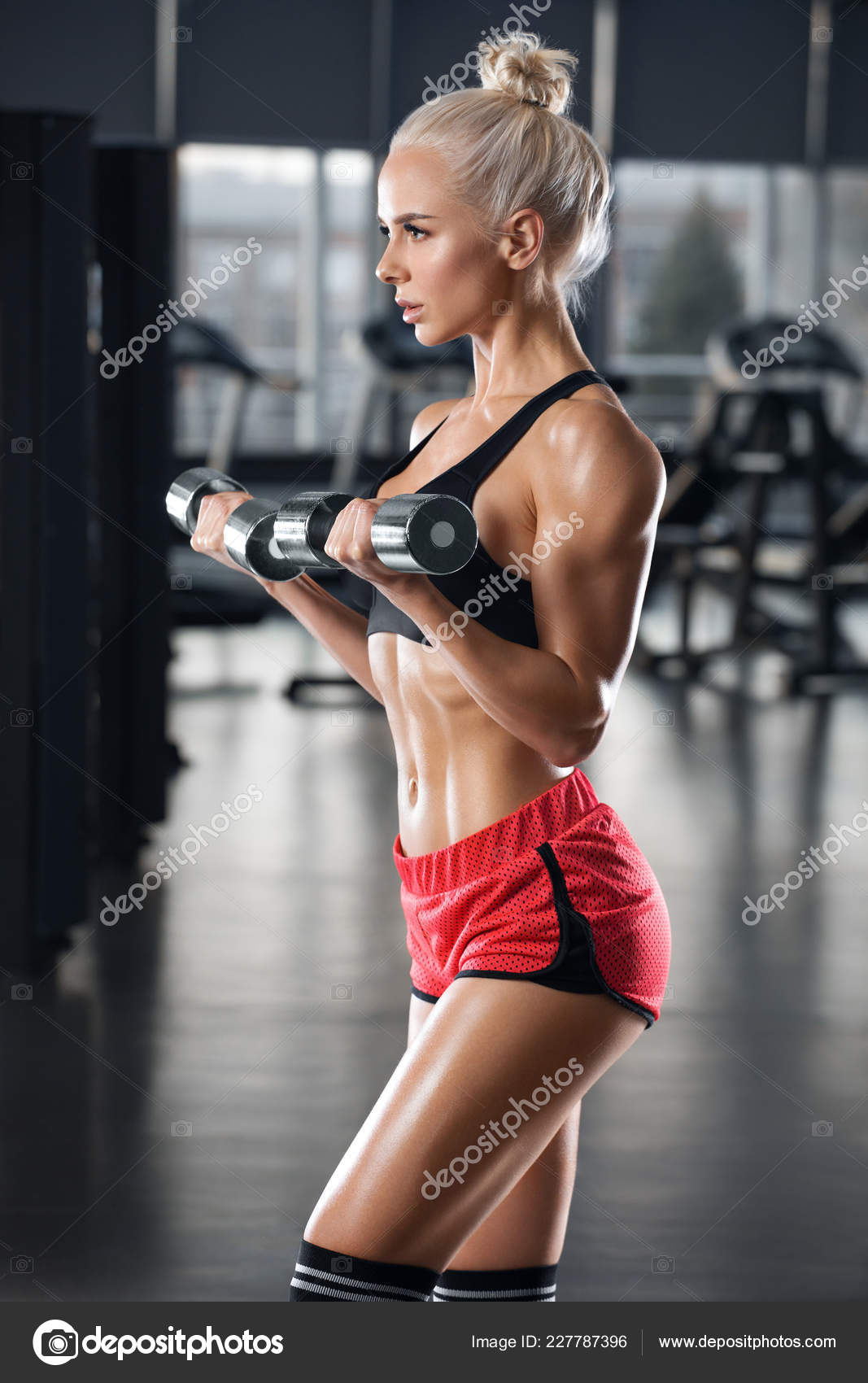 Sexy Athletic Girl Working Out In Gym. Fitness Woman Doing