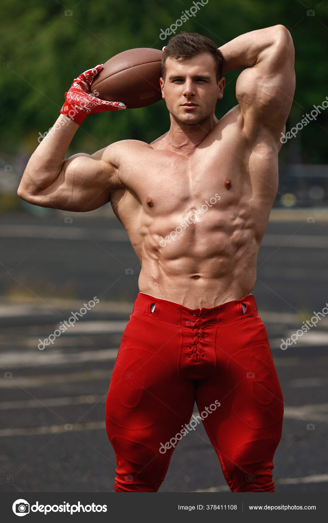 Muscular Man in Black Compression Sportswear on Gray Background