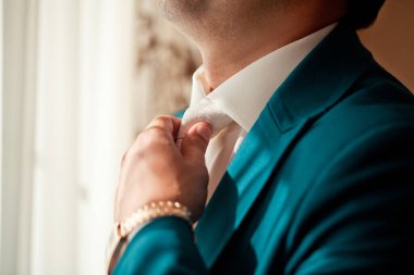 Bir erkek kravatını düzeltir.